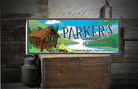 Personalized cabin sign featuring a cartoon log cabin, blazing campfire, and flowing river, with customizable text for a unique getaway decor.