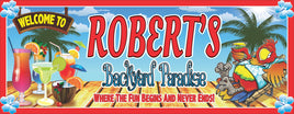 Personalized backyard paradise welcome sign featuring a tropical parrot relaxing on a chaise lounge with a cocktail in his hand, surrounded by exotic drinks. All lines of text are editable for a custom touch.