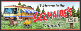Personalized RV camping welcome sign featuring distant pine trees, a crackling campfire surrounded by wooden chairs, and a custom name. All lines of text are editable.