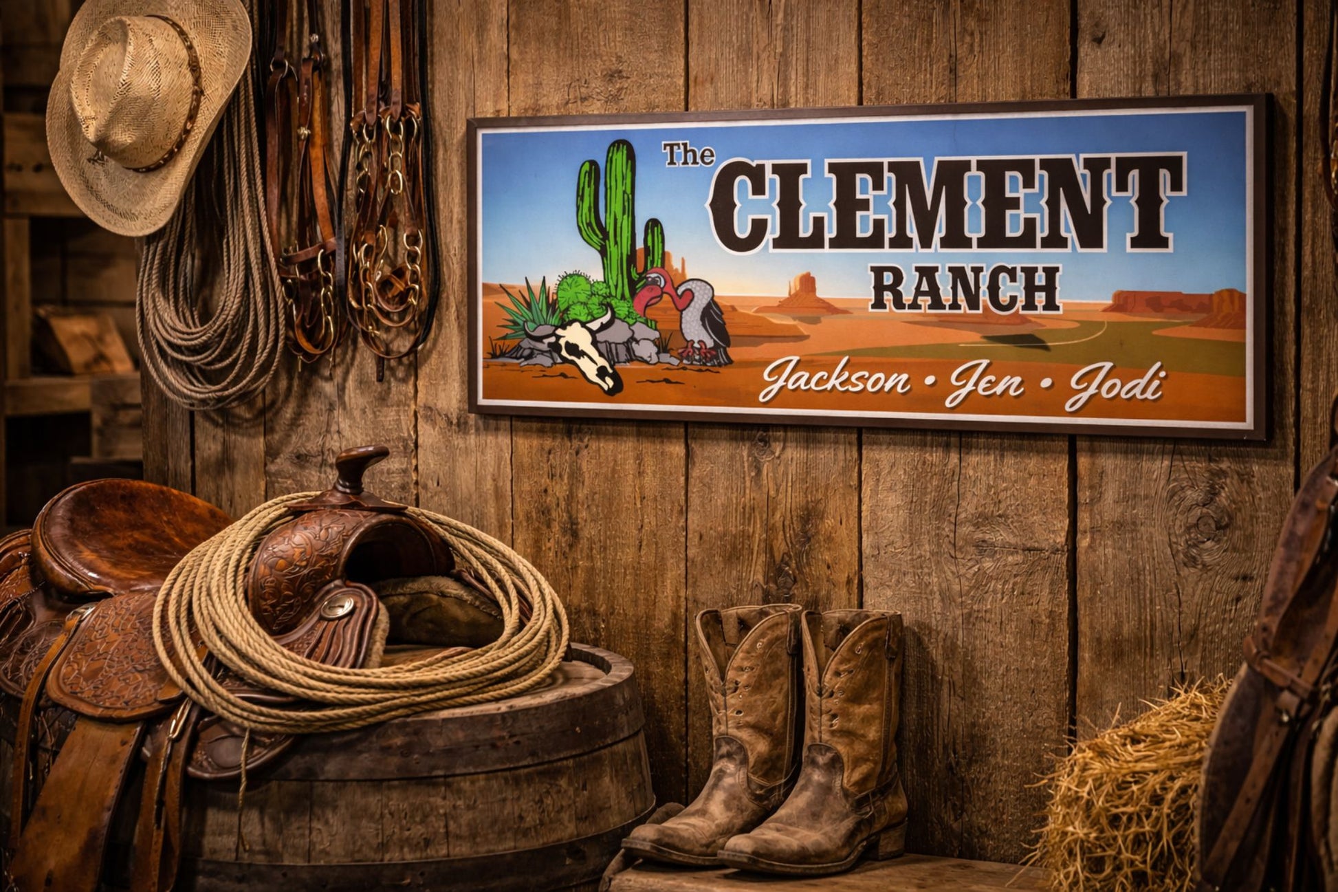 Western ranch sign mounted on a rustic barn wall with cowboy hat, rope, and country décor
