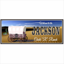 Personalized ranch welcome sign with covered wagon, western landscape, and custom family name on white background