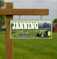 Personalized farm name sign hanging from wooden post in grassy farm setting