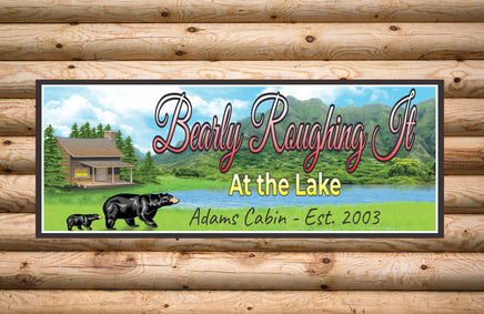 Custom Black Bear Lodge Sign featuring a serene stream, tall pine trees, and a cozy log cabin in the wilderness