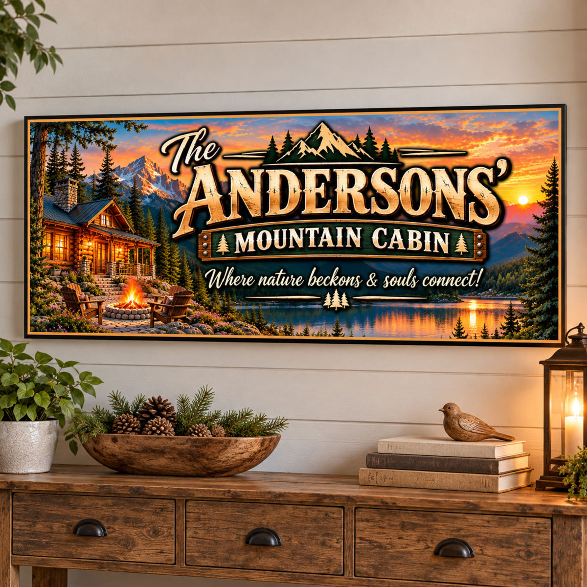 Custom mountain lodge family sign displayed above a wooden console table with greenery, decorative lantern and rustic home accessories.