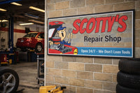 Repair Shop sign mounted on a garage wall with tools, tires, and automotive decor