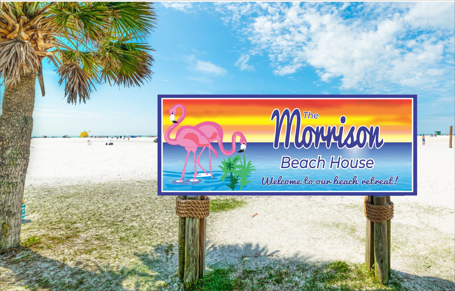 Personalized flamingo beach house sign displayed outdoors near sandy beach and palm trees