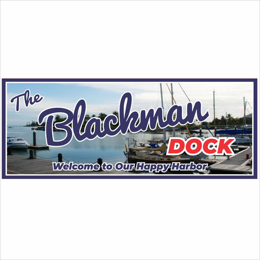 Personalized dock sign displayed on a wooden marina wall with boats in the background