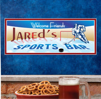 Personalized Hockey Sports Bar Sign featuring an illustration of a hockey player, a puck, a goal, and an ice rink. The sign is designed to enhance sports bars and fan zones, customizable with team names or personal messages.