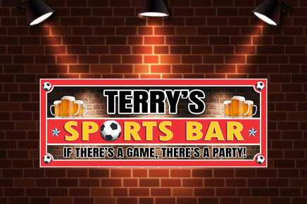 Personalized sports bar sign featuring an eye-catching red brick background with a bold red border, decorated with soccer balls in each corner and one replacing the 'O' in 'Sports Bar'. The sign includes customizable text, frothy beer mugs, and tailored to match team colors for a unique game day display.
