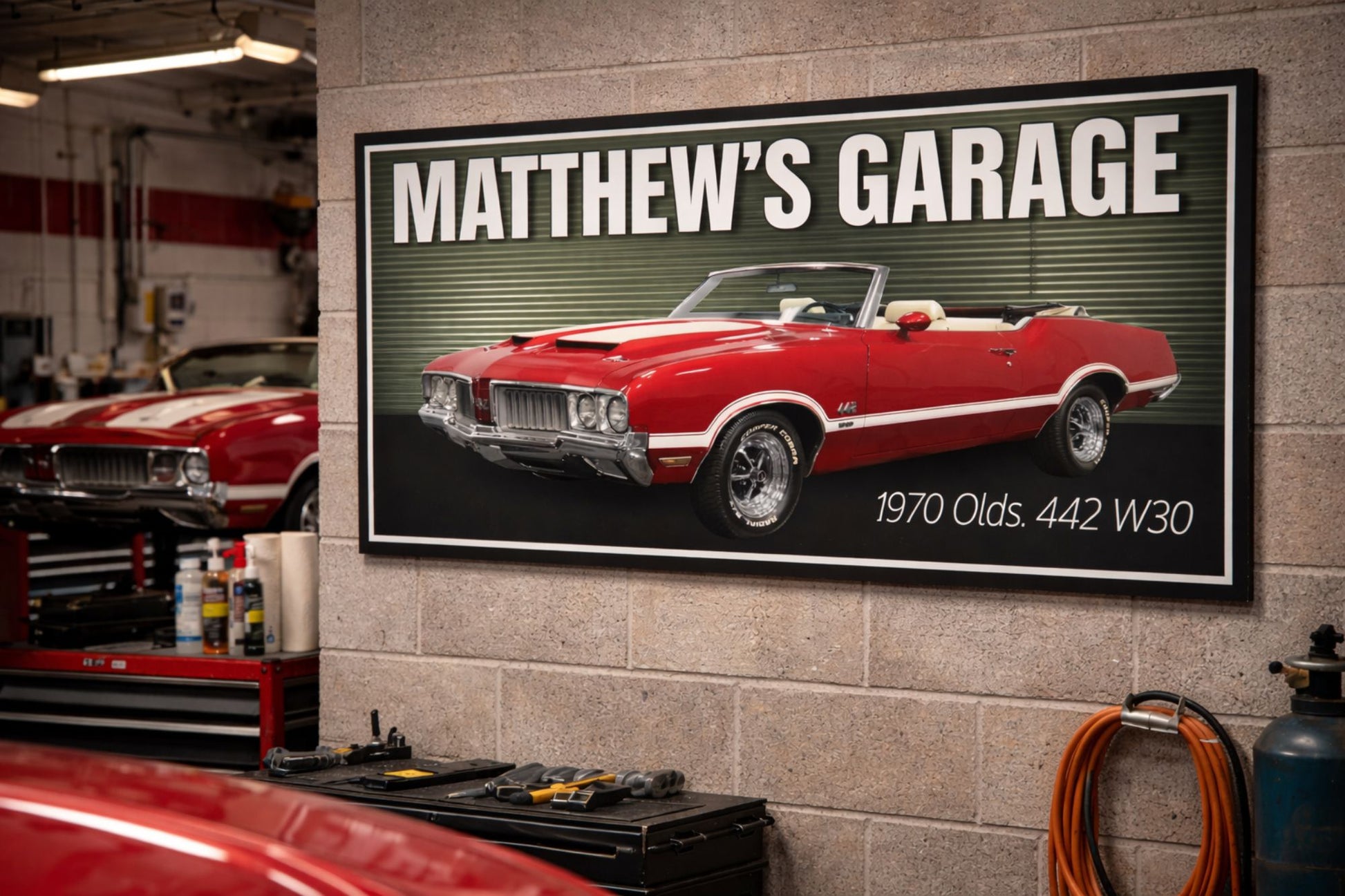 1970 muscle car garage sign mounted on a workshop wall with tools and automotive decor