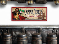 Custom bar sign for Captain Morgan featuring a vivid illustration of a green parrot perched on a rum barrel, with a dark silhouette of a pirate ship in the background. The sign includes decorative text personalized with the name 'Captain Morgan' styled to evoke a nautical theme. The overall color scheme highlights oceanic blues and greens, creating a lively and adventurous ambiance
