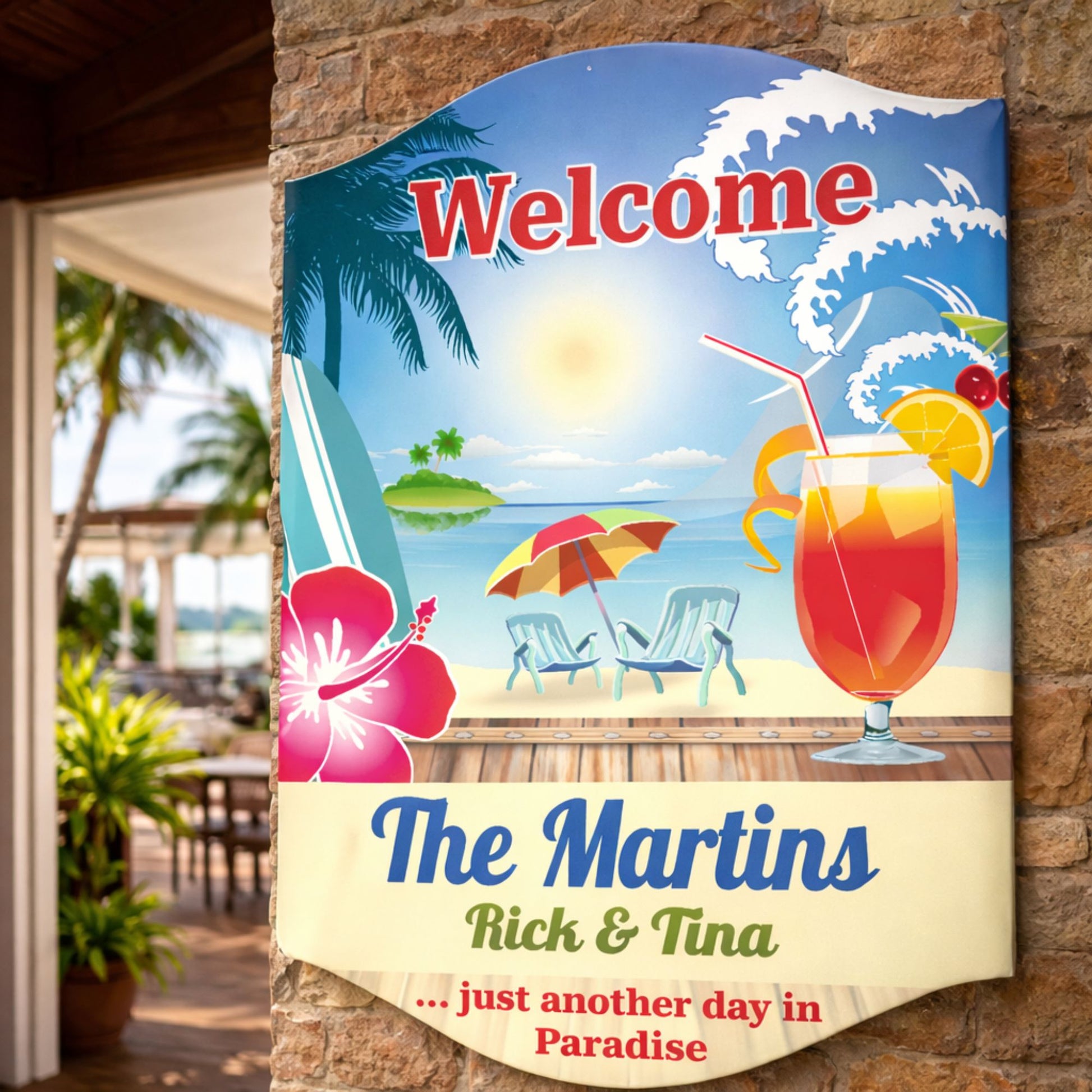 Tropical personalized welcome sign mounted on an outdoor wall in a coastal setting with palm trees and beach décor