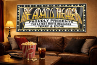Home theater room with leather couch, popcorn, and a marquee-style movie sign mounted on the wall