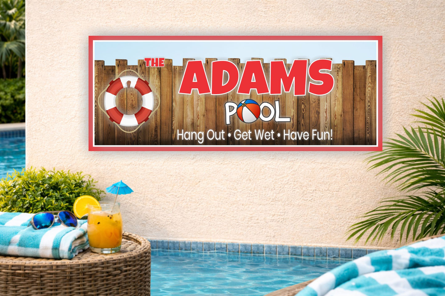personalized family pool sign mounted on stucco wall beside backyard swimming pool