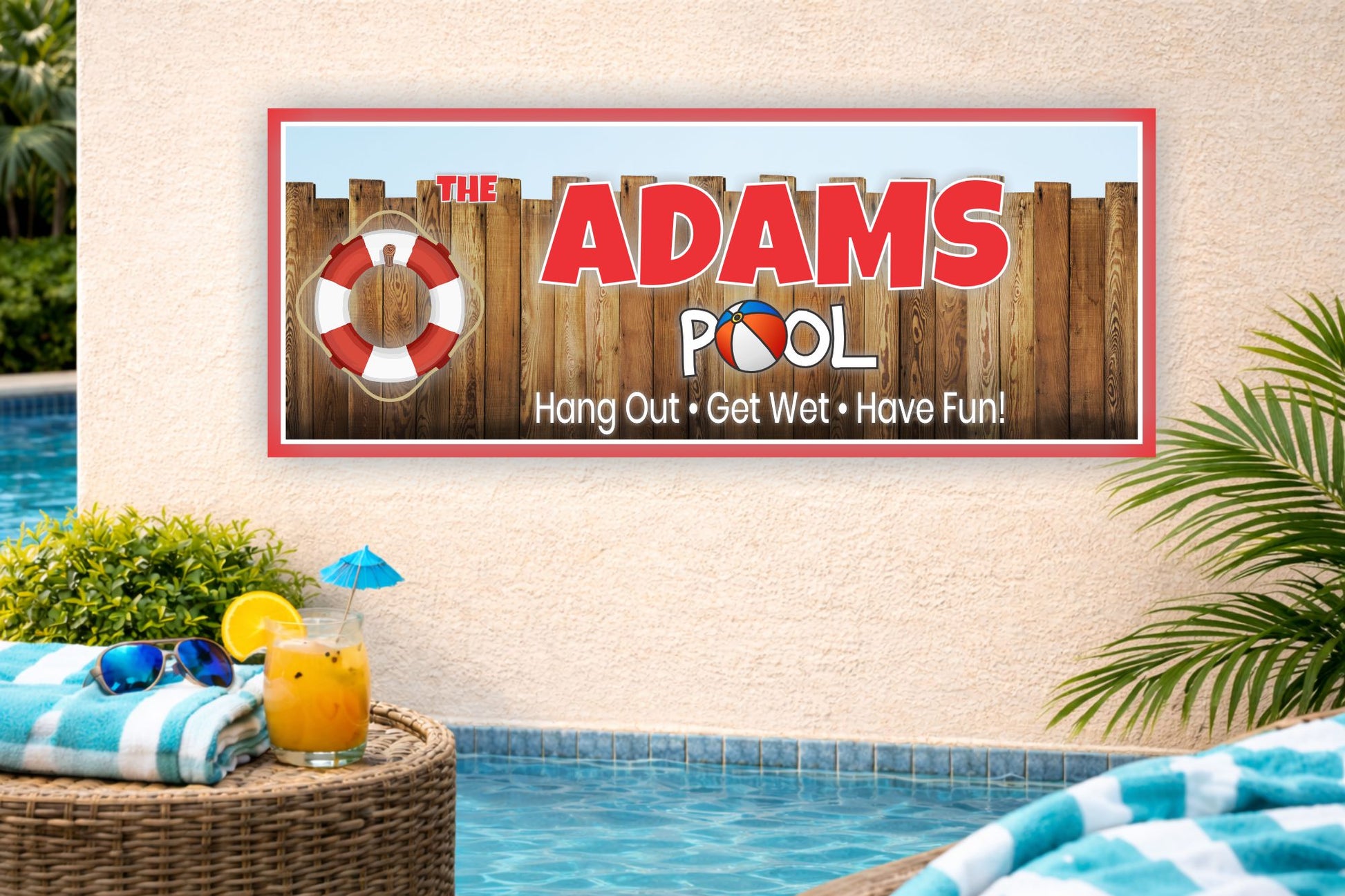 personalized family pool sign mounted on stucco wall beside backyard swimming pool