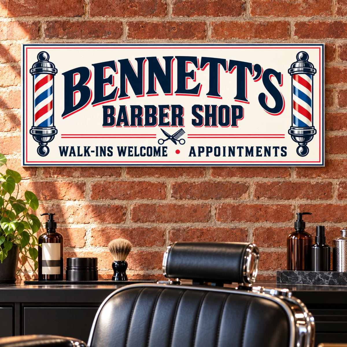 Personalized ivory, navy, and red barber shop sign mounted on a brick wall above a black leather barber chair and grooming station.