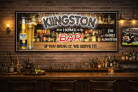 Lifestyle image showing personalized home bar sign mounted on a brick wall above a fully stocked bar counter