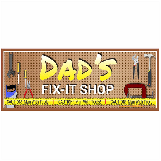 Close-up of personalized garage workshop sign with pegboard background, yellow lettering, and illustrated tools