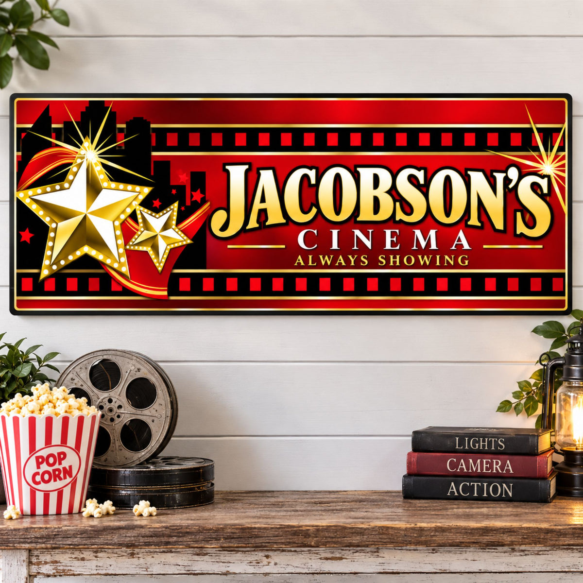 Personalized home theater wall sign displayed above a shelf with movie reels, popcorn and cinema décor.