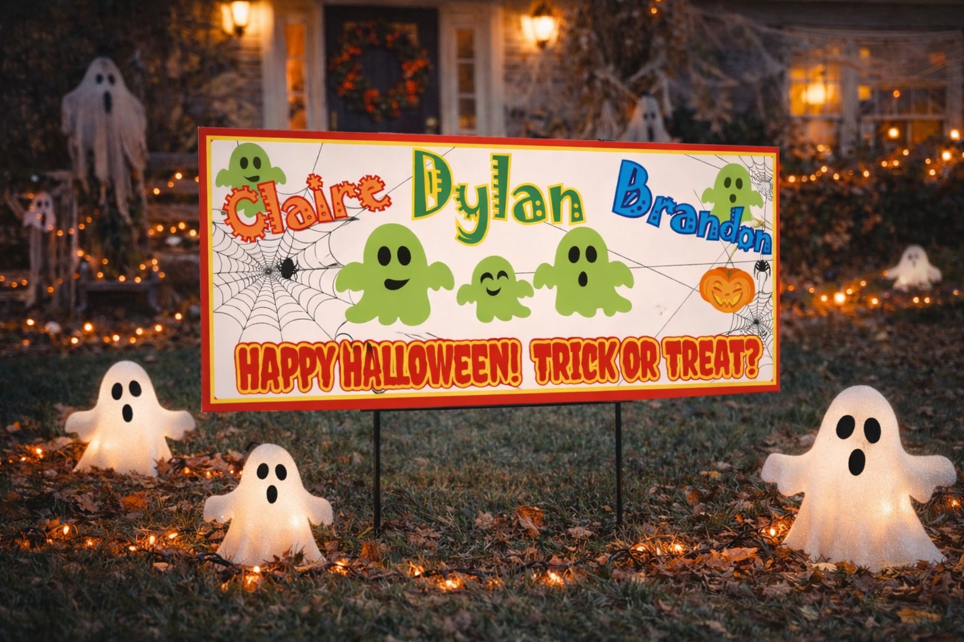 custom halloween sign displayed on a yard post with ghosts and fall decorations