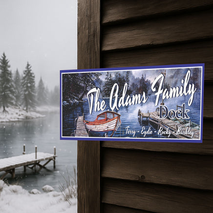 Personalized dock sign mounted on a rustic cabin exterior in winter