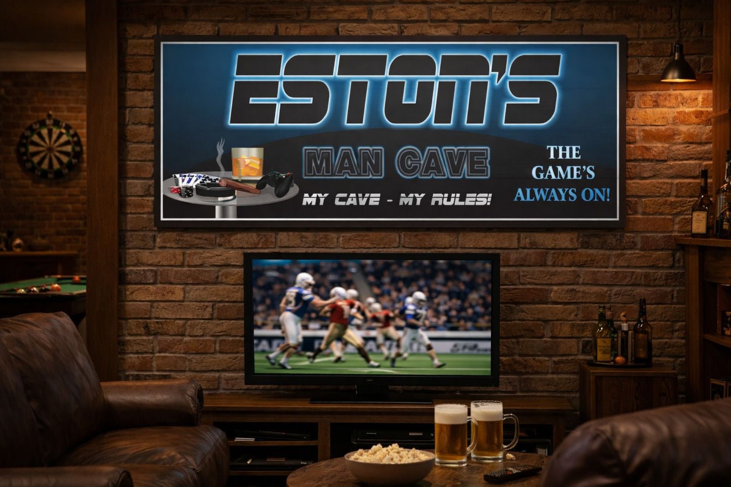 Personalized man cave sign with printed illuminated-style design mounted above a TV in a rustic game room with leather seating and sports décor