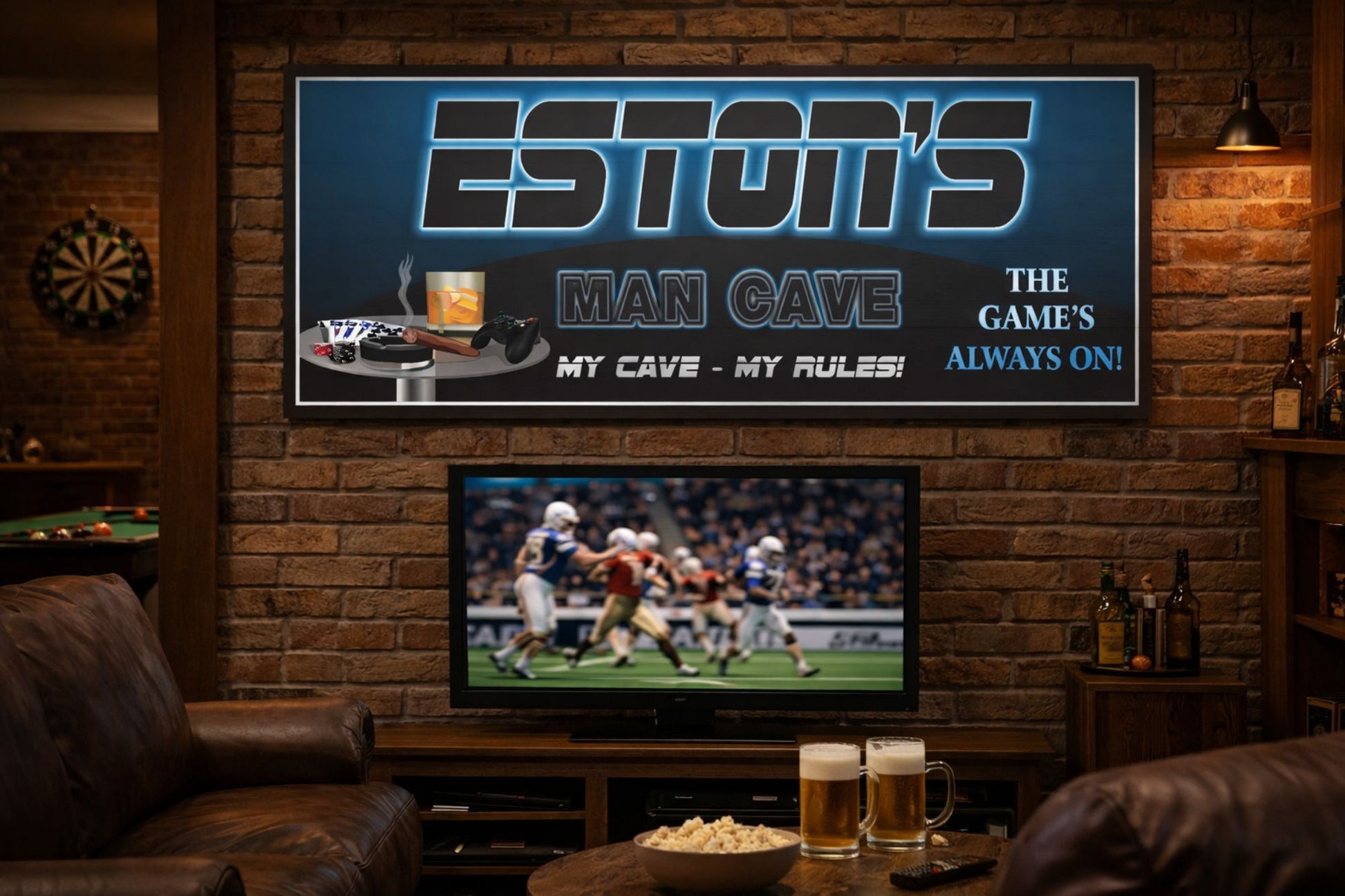 Personalized man cave sign with printed illuminated-style design mounted above a TV in a rustic game room with leather seating and sports décor