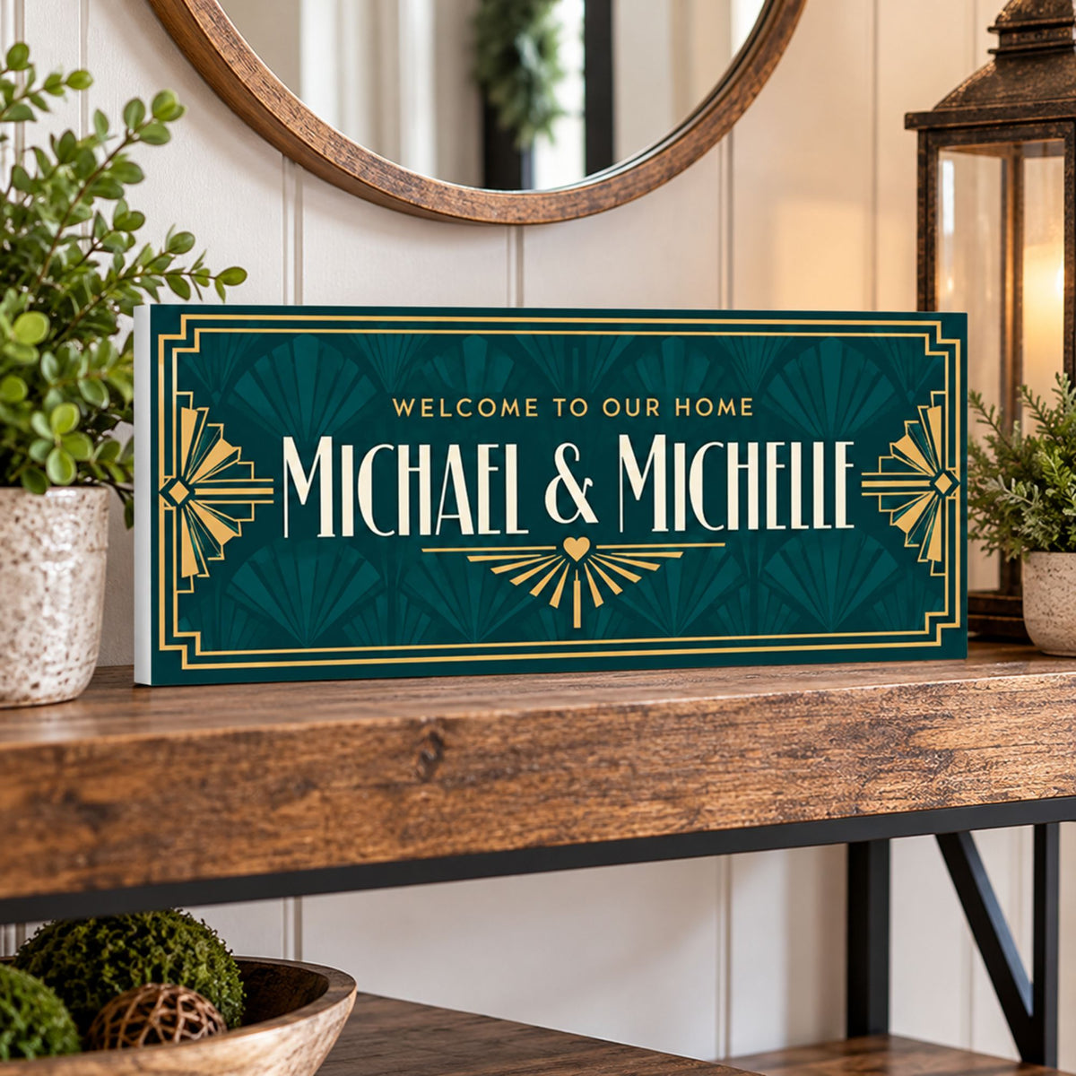 Personalized teal and gold Art Deco welcome sign displayed on a wooden entryway console shelf with plants and lantern.