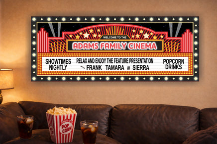Custom cinema marquee sign mounted on a wall above a couch with popcorn and drinks