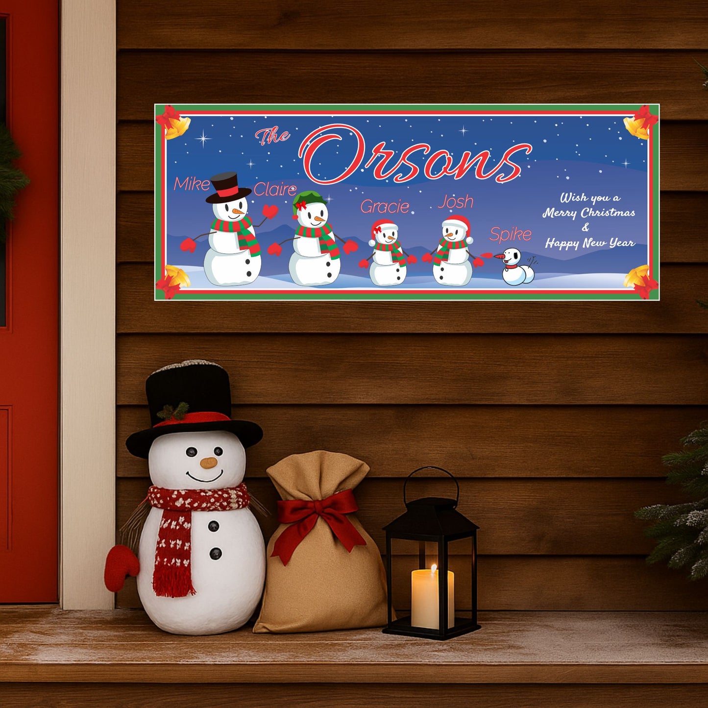 Personalized snowman Christmas sign displayed on a wooden shelf with holiday décor, lantern, and festive decorations