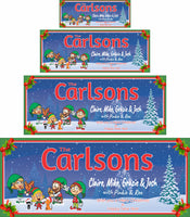 Personalized Christmas sign featuring Santa's elves family with a dog and cat, wishing everyone a Merry Christmas, framed by a holly berry border.