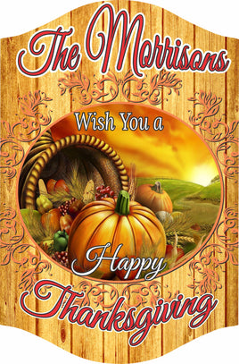 Personalized Thanksgiving sign with cornucopia, pumpkins, autumn sunset, faux wood plank background, and editable text.