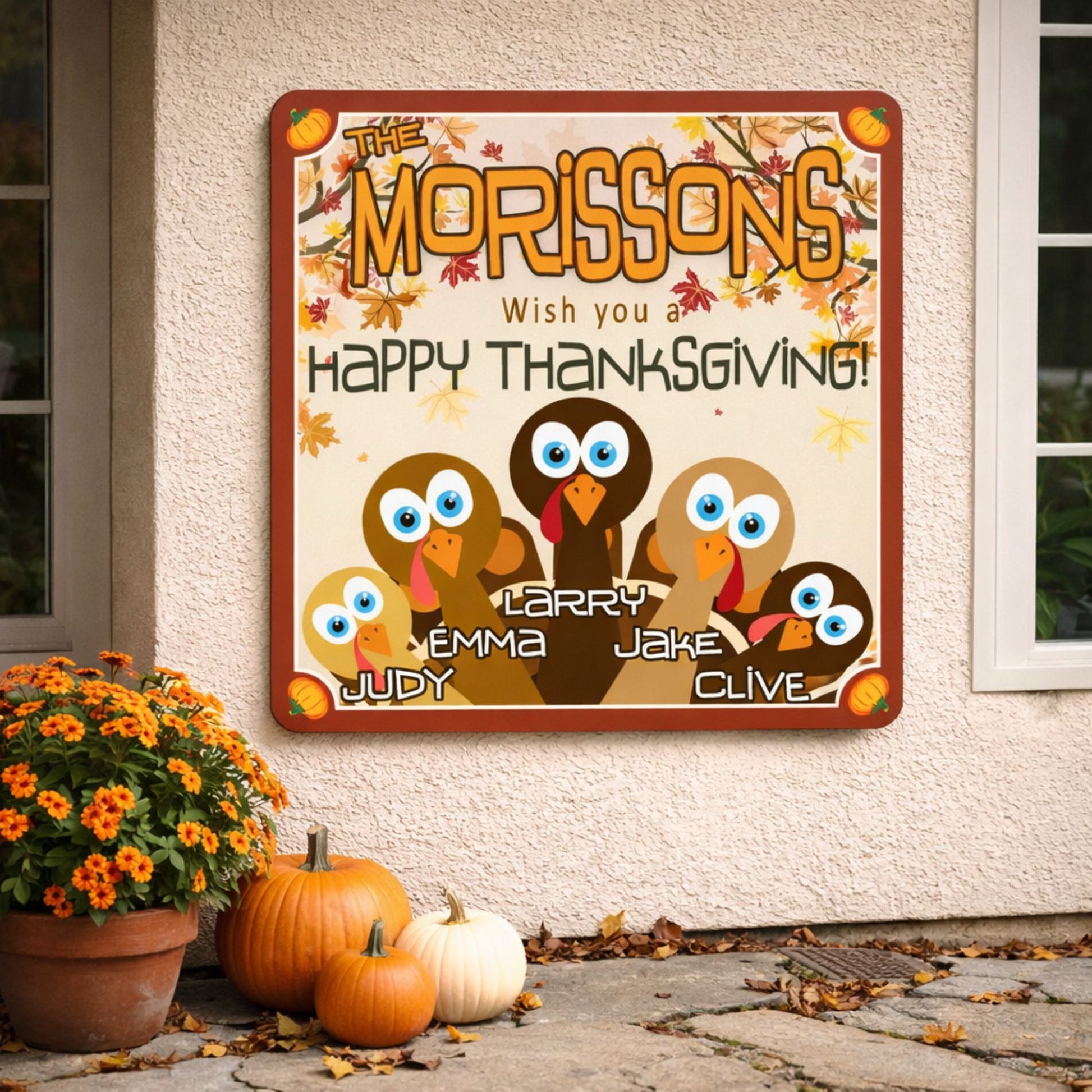 Personalized Thanksgiving family sign displayed on an exterior wall with pumpkins and fall decor near an entryway