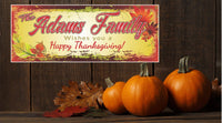 Personalized Happy Thanksgiving sign featuring a family name, colorful fall leaves background, and editable text for a custom greeting.