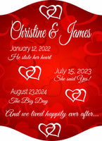 Romantic personalized sign for couples featuring custom names, three important dates, and the quote "and we lived happily ever after" on a rich red background with interlocking heart illustrations. All lines of text are editable. Perfect for weddings, anniversaries, or Valentine's Day gifts.