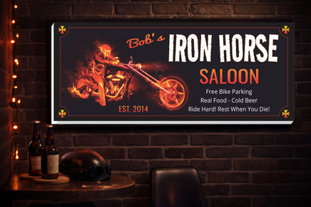 Custom biker bar sign displayed on a dark interior wall in a home bar setting