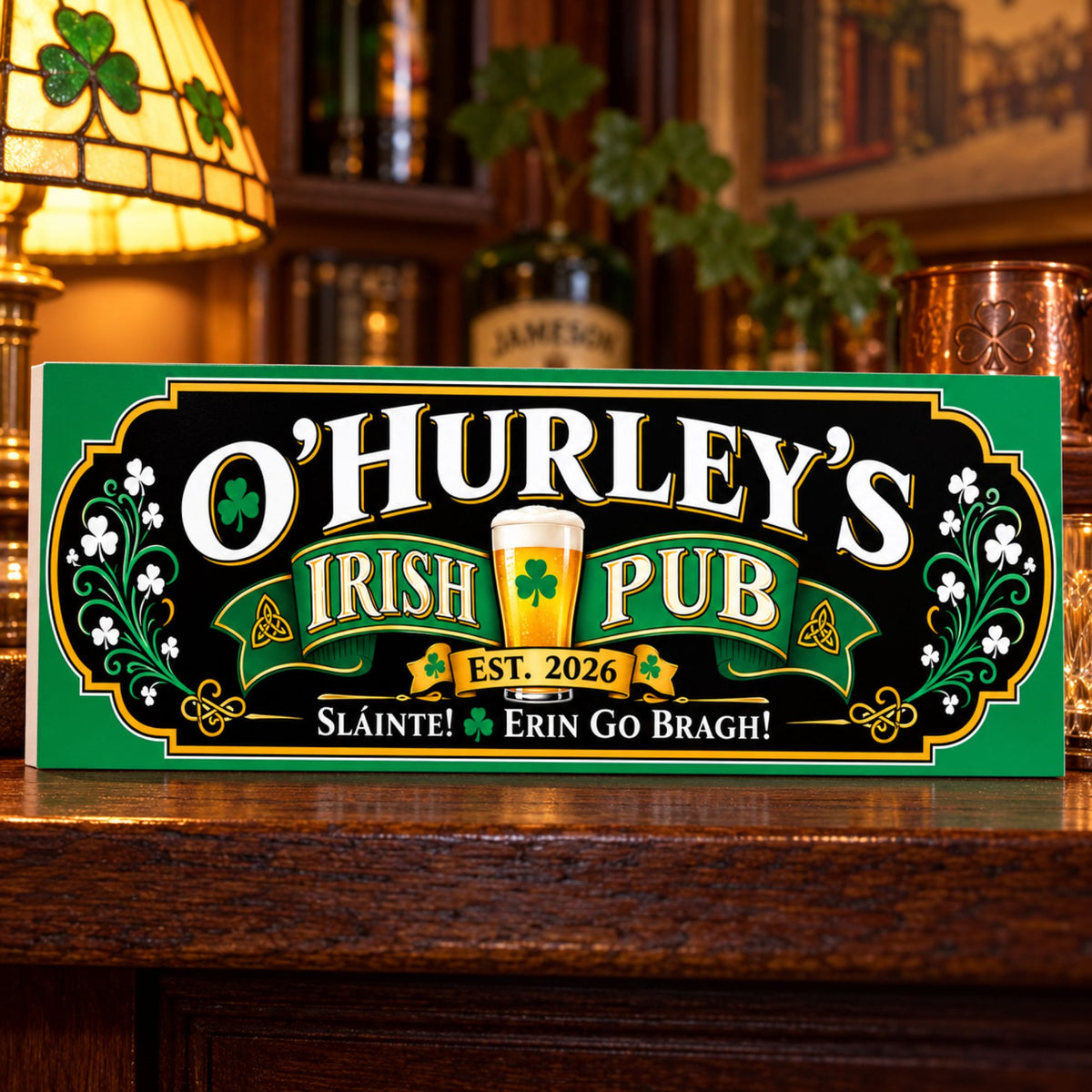 Personalized Irish pub sign with shamrocks, beer glass artwork, and white and gold lettering displayed on a wooden shelf in a cozy home bar.