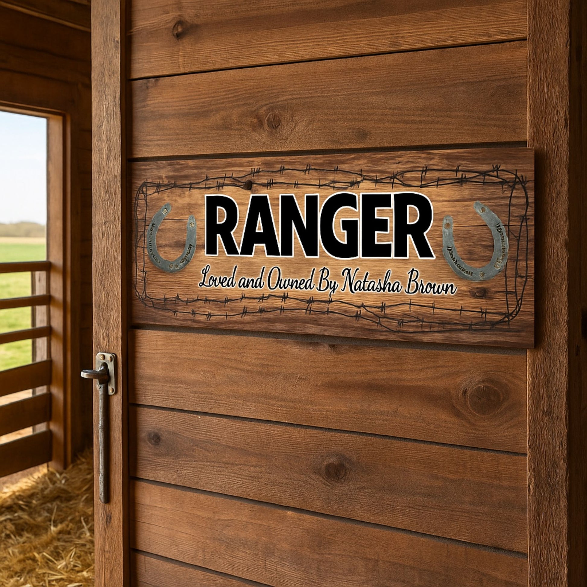 Horse name sign displayed on wooden barn door