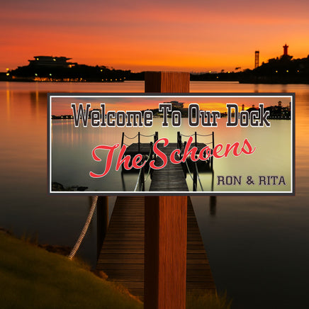 Dock welcome sign displayed on a waterfront dock at sunset