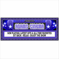 Home theater room with a personalized cinema marquee wall sign, movie-style lights, red theater seats, curtains, and popcorn on the armrest.