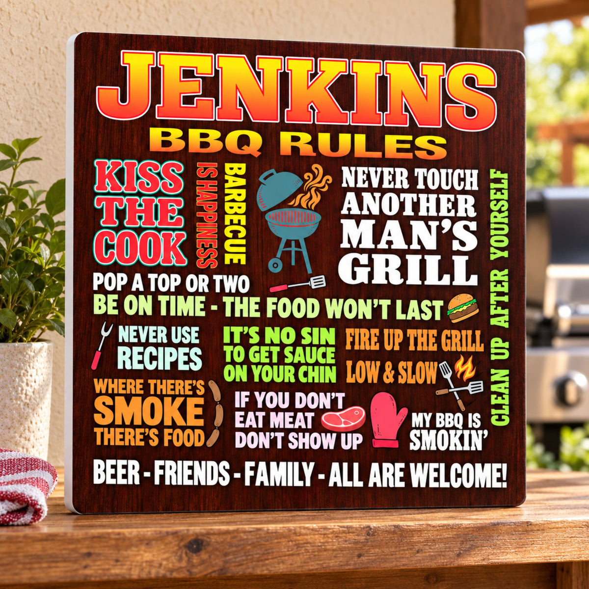 Custom BBQ rules sign displayed on a wooden outdoor kitchen shelf, showing its white PVC edge on the left.
