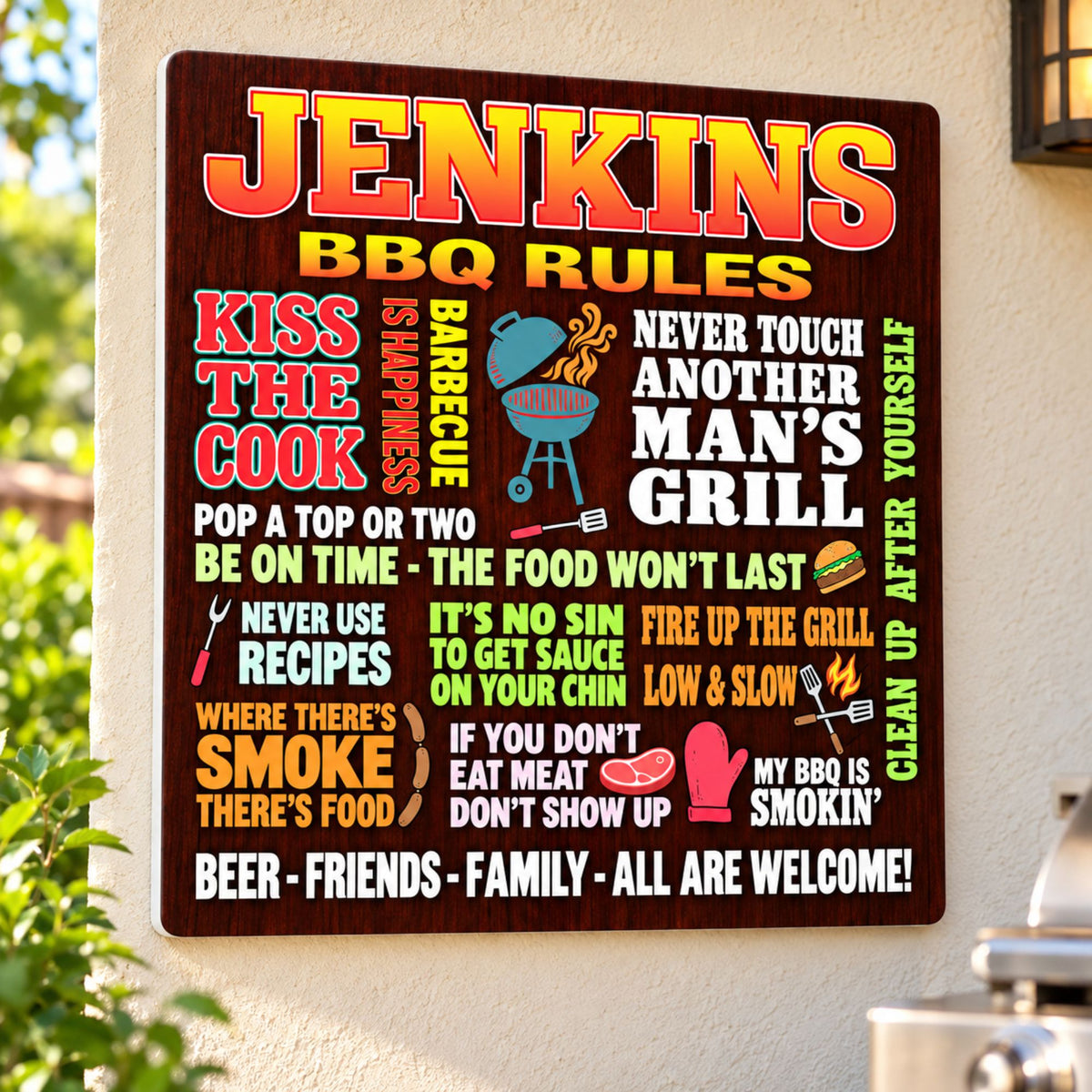 Personalized BBQ rules sign mounted on a cream patio wall near a grill, with its white PVC edge visible.