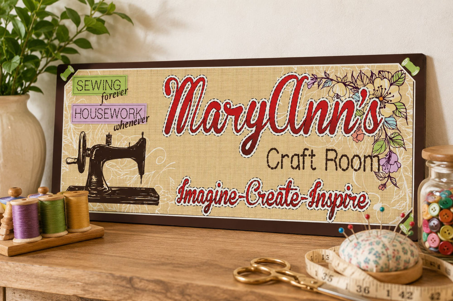Close-up personalized craft room sign displayed on sewing table with thread spools scissors and sewing accessories