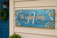 Coastal family name sign mounted on exterior house wall by front door