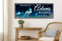 coastal entryway with wicker chair and console table featuring a mermaid beach house sign on the wall