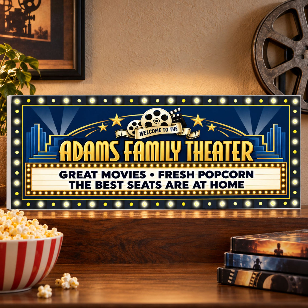 Personalized theater sign on a walnut shelf beside popcorn and movie cases, showing a subtle white PVC edge.