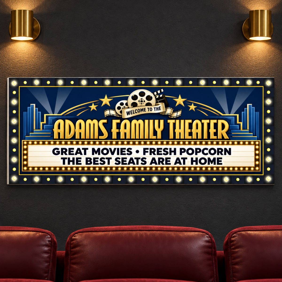 Custom cinema sign mounted on a charcoal wall above burgundy theater seats, featuring navy and gold artwork and printed bulbs.