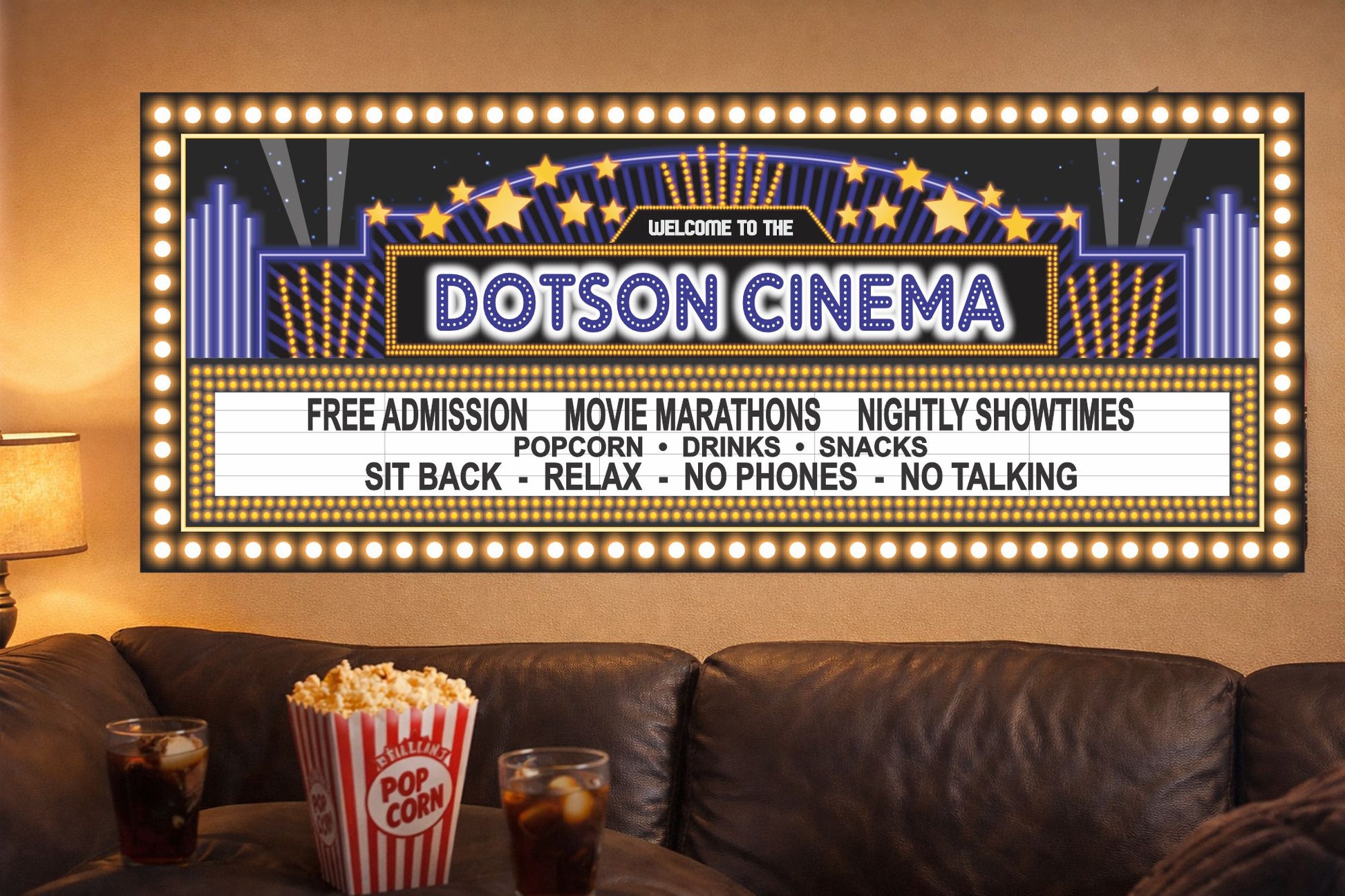 personalized home theater marquee sign hanging above sofa with popcorn and drinks in movie room