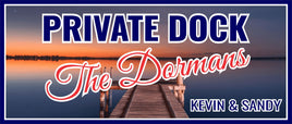 Personalized private dock sign with bold navy lettering and script message over a peaceful lake background, customizable for family name or wording