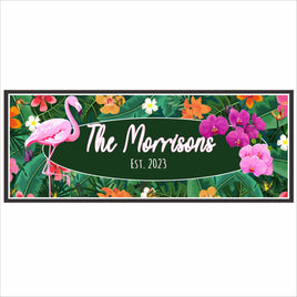 tropical flamingo family name sign displayed on a patio wall with plants and bright summer decor